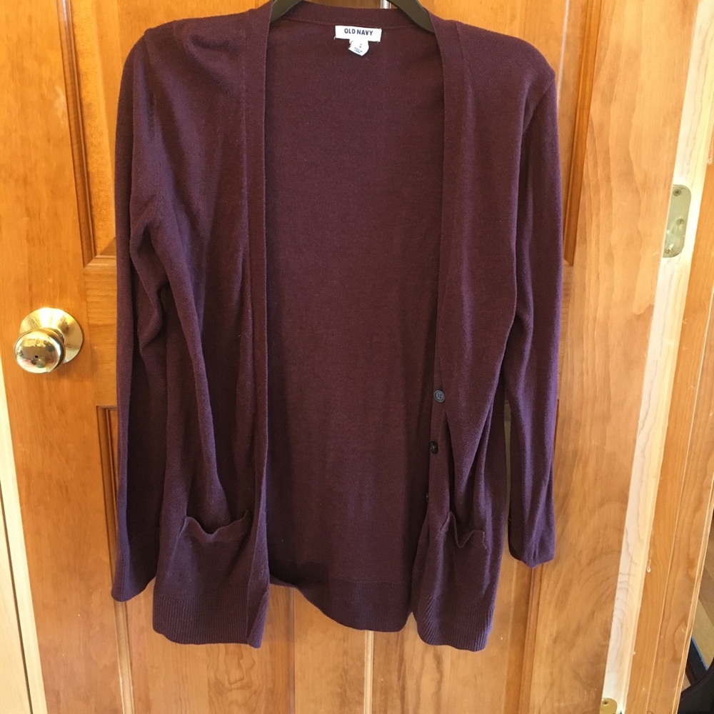 A magenta cardigan sweater.